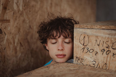 Portrait of boy looking away against wall