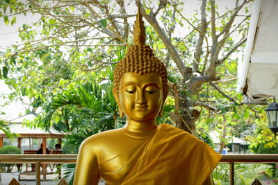 Statue of buddha against trees