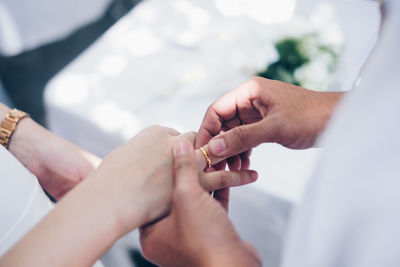 Midsection of couple holding hands