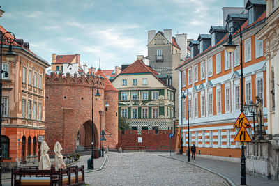 Buildings in town against sky