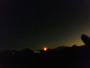 Scenic view of silhouette mountain against sky at night