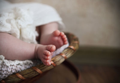 Midsection of baby girl sitting on table