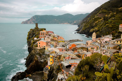 High angle view of buildings by sea against sky