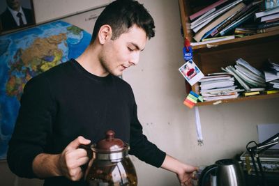 Young man looking at camera at home