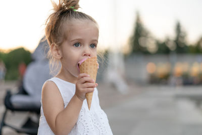Portrait of cute girl holding ice cream