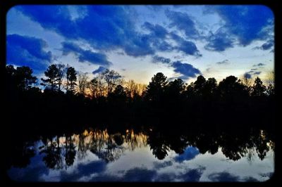 Scenic view of lake against cloudy sky