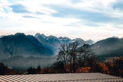 Scenic view of trees and mountains against sky