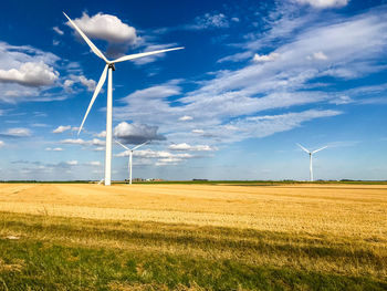 Windmill on field against sky