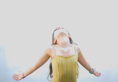 Midsection of woman standing against white background