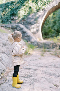 Rear view of boy running on field