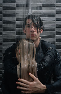 Portrait of man embracing female partner in shower