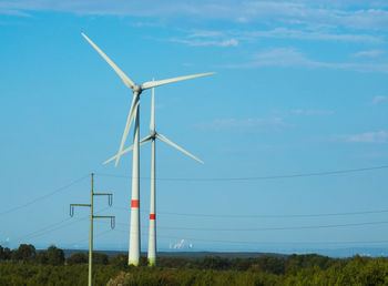 Windmill on field against sky