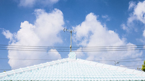 Low angle view of cables against blue sky