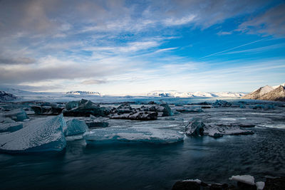 Scenic view of frozen lake against sky