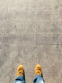 Low section of man standing on tiled floor