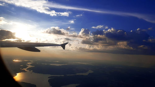 Airplane flying in sky during sunset