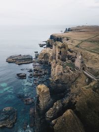 High angle view of rocks on shore against sky