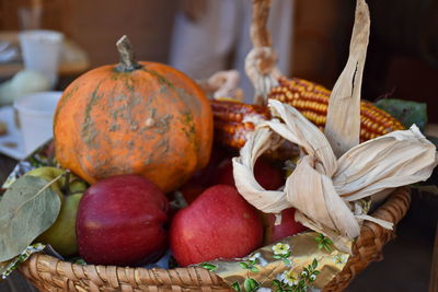 Close-up of pumpkins in basket on table at market