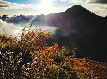 Scenic view of mountains against cloudy sky