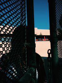 Woman standing by fence