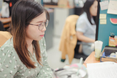 Young woman looking at book