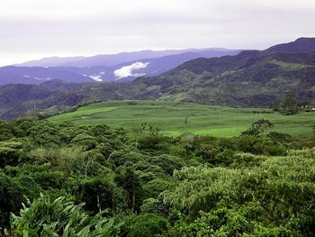 Scenic view of landscape and mountains against sky