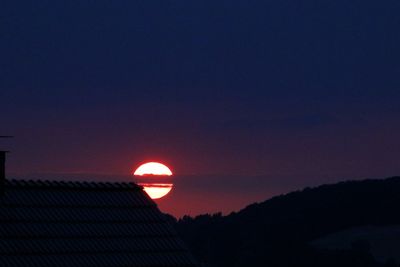 Silhouette mountain against clear sky during sunset