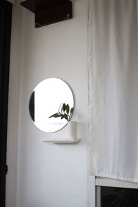 Low angle view of illuminated lamp on wall