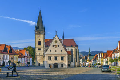 View of buildings against blue sky in city