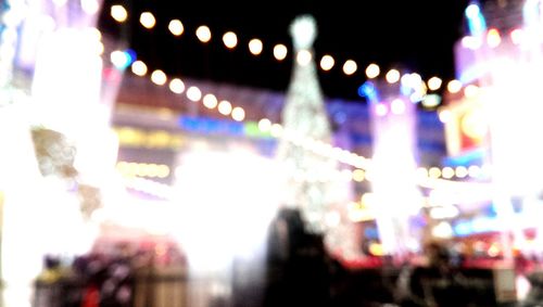 Defocused image of illuminated city street at night