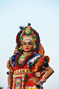 Portrait of woman in costume standing against clear sky