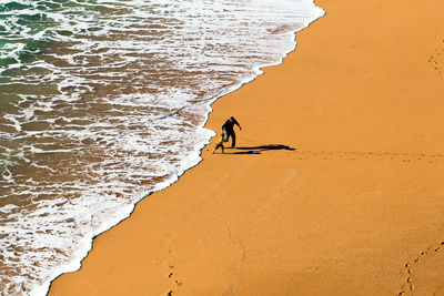 High angle view of man surfing in sea