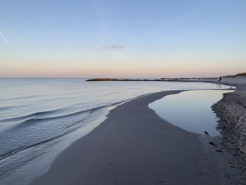 Scenic view of beach against sky during sunset