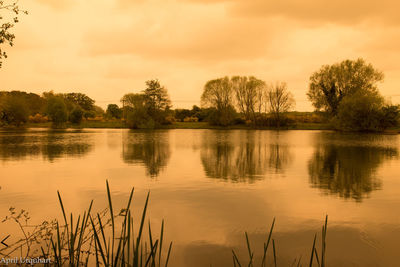 Scenic view of lake against sky during sunset