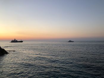 Scenic view of sea against clear sky during sunset