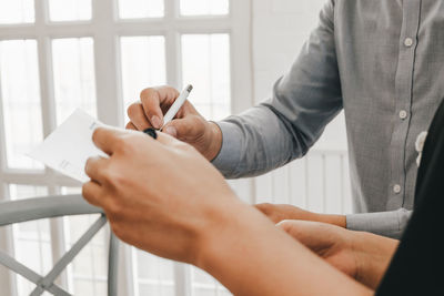 Midsection of couple holding hands