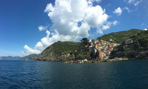 Panoramic view of sea and buildings against sky