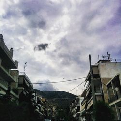 Low angle view of building against cloudy sky