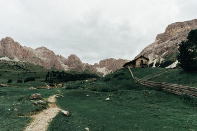 Scenic view of land and mountains against sky