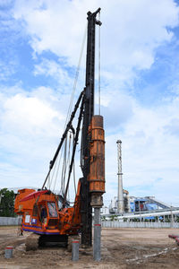 Low angle view of crane against sky