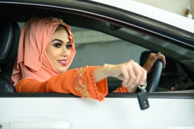 Portrait of young woman in car
