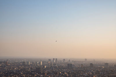 Aerial view of city against sky during sunset