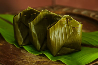 Close-up of green leaves on table
