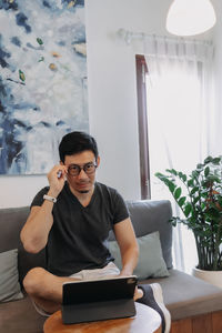 Young man using laptop at home