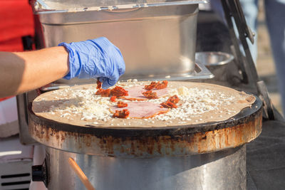 Demonstration cooking, chef making pancakes at naplavka street food market.