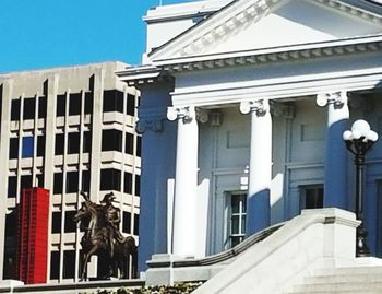 Low angle view of statue against historic building