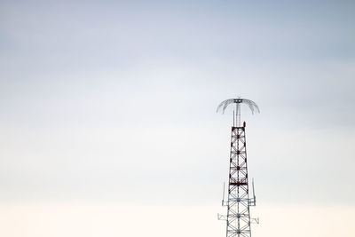 Low angle view of communications tower against sky