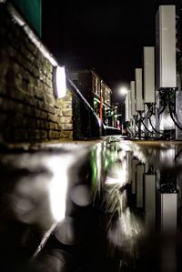 Reflection of illuminated building in mirror