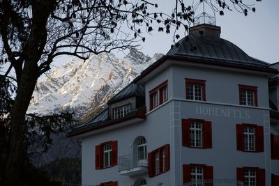 Low angle view of building and trees against sky