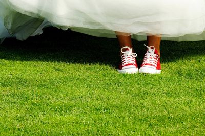 Low section of woman standing on grass